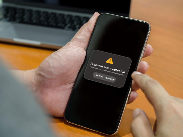 Smartphone displaying a suspicious message while illustrating WhatsApp scam prevention in Pakistan.